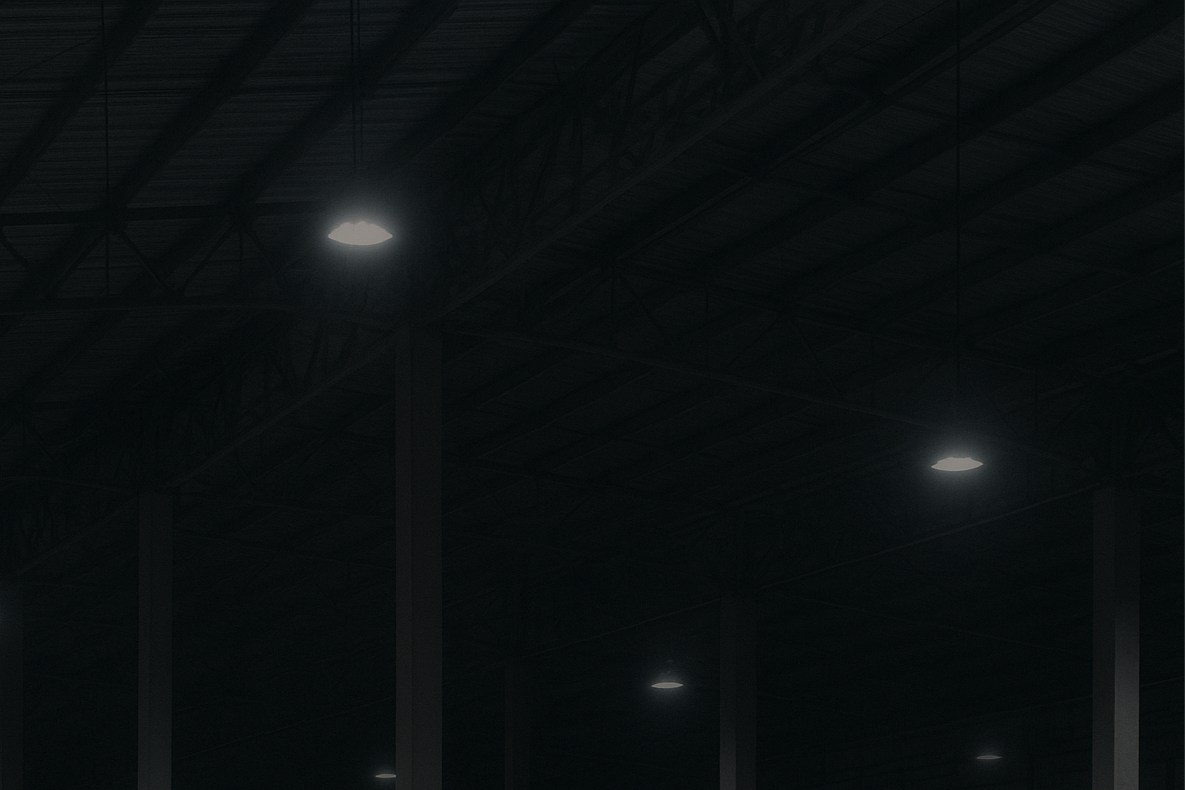 Dark warehouse interior with wooden pallets and stacked boxes.